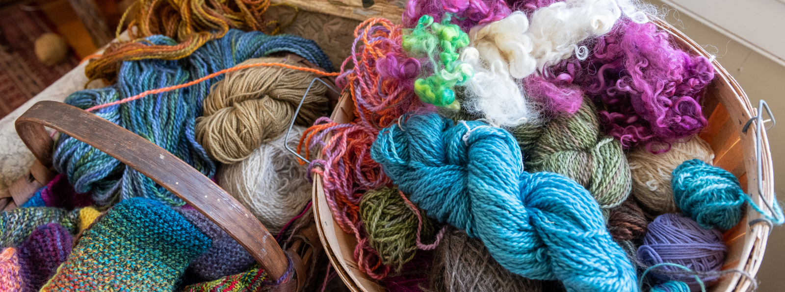 Two baskets containing balls of yarn.